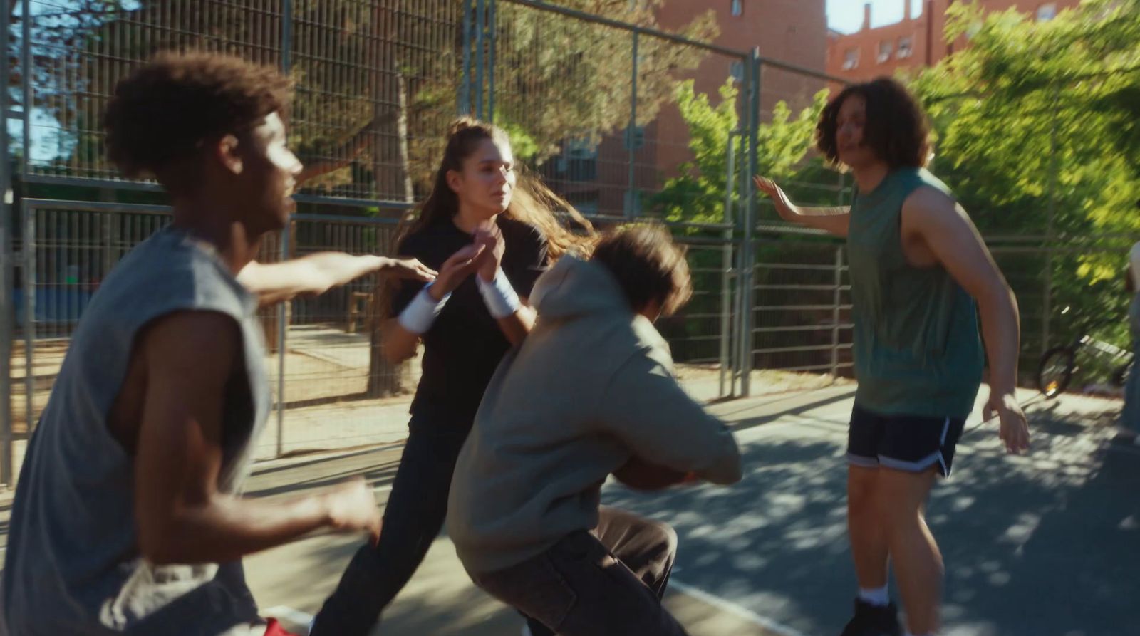 a group of young people playing a game of basketball