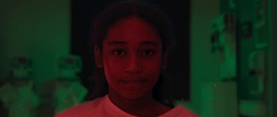 a woman in a red light room looking at the camera