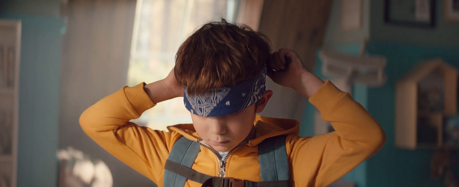 a young boy with a blindfold on his head