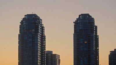 a couple of tall buildings sitting next to each other