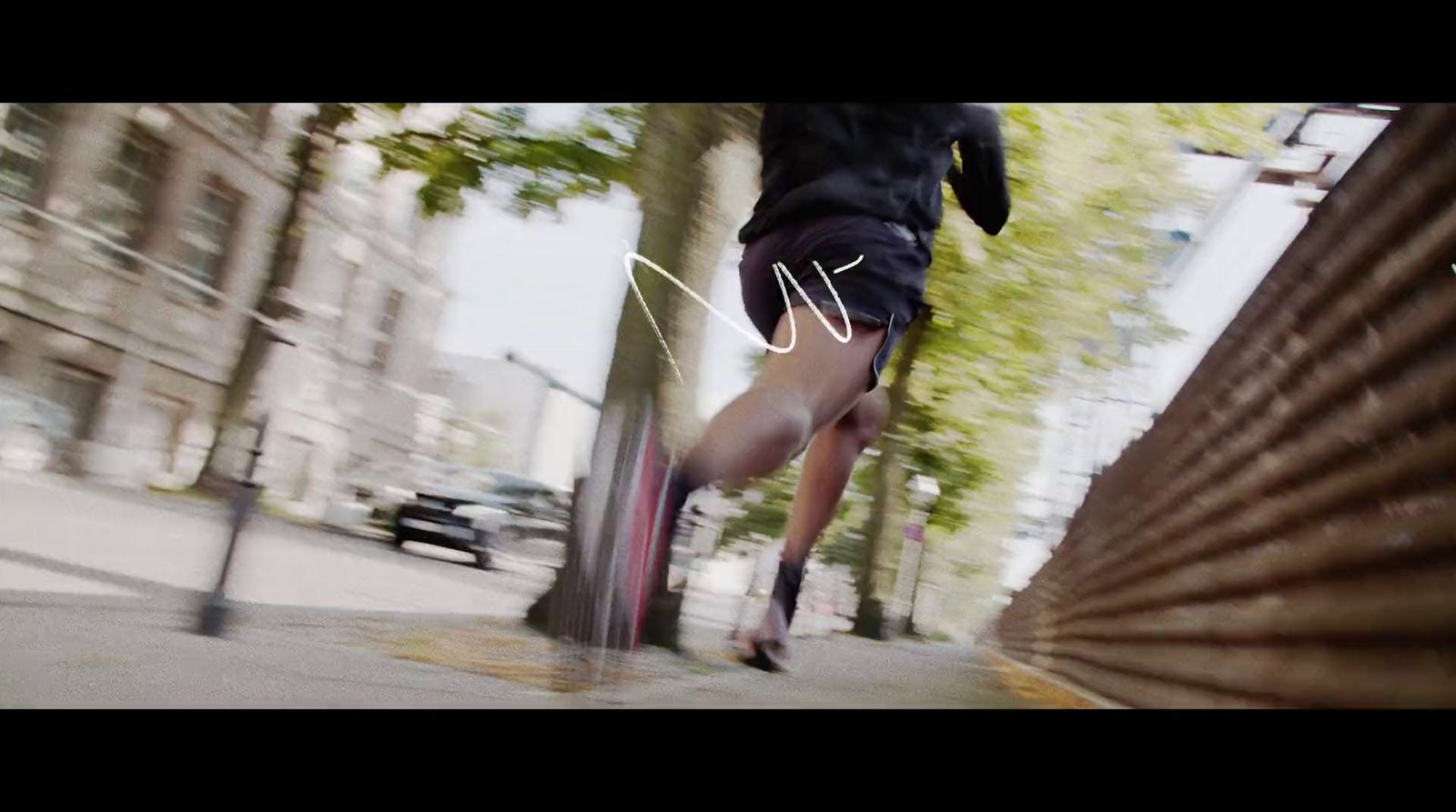 a man is running down a city street