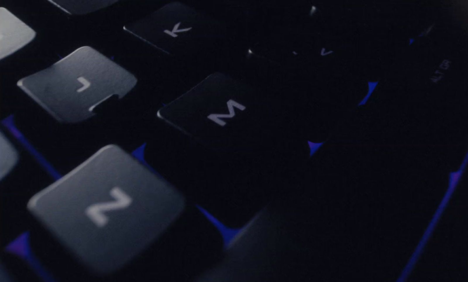 a close up of a black keyboard with blue keys