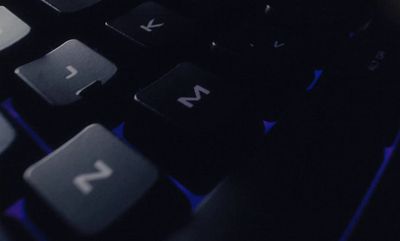 a close up of a black keyboard with blue keys