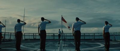 a group of people standing on top of a boat