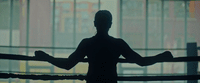 a silhouette of a person in a boxing ring