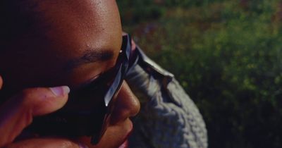 a close up of a person talking on a cell phone