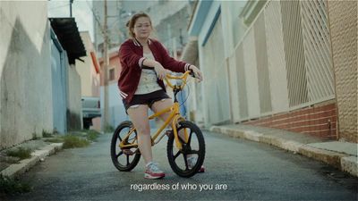 a woman riding a yellow bike down a street