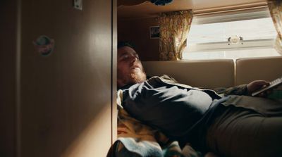 a man laying on a bed in a room