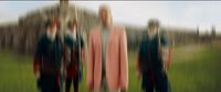 a blurry photo of three people standing in a field