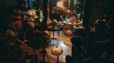 a living room filled with furniture and a lamp