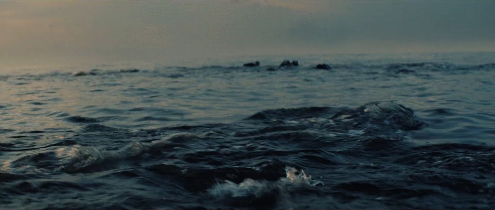 a group of people riding on the back of a boat in the ocean