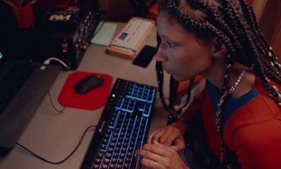 a woman sitting in front of a laptop computer