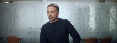 a man standing in front of a glass wall