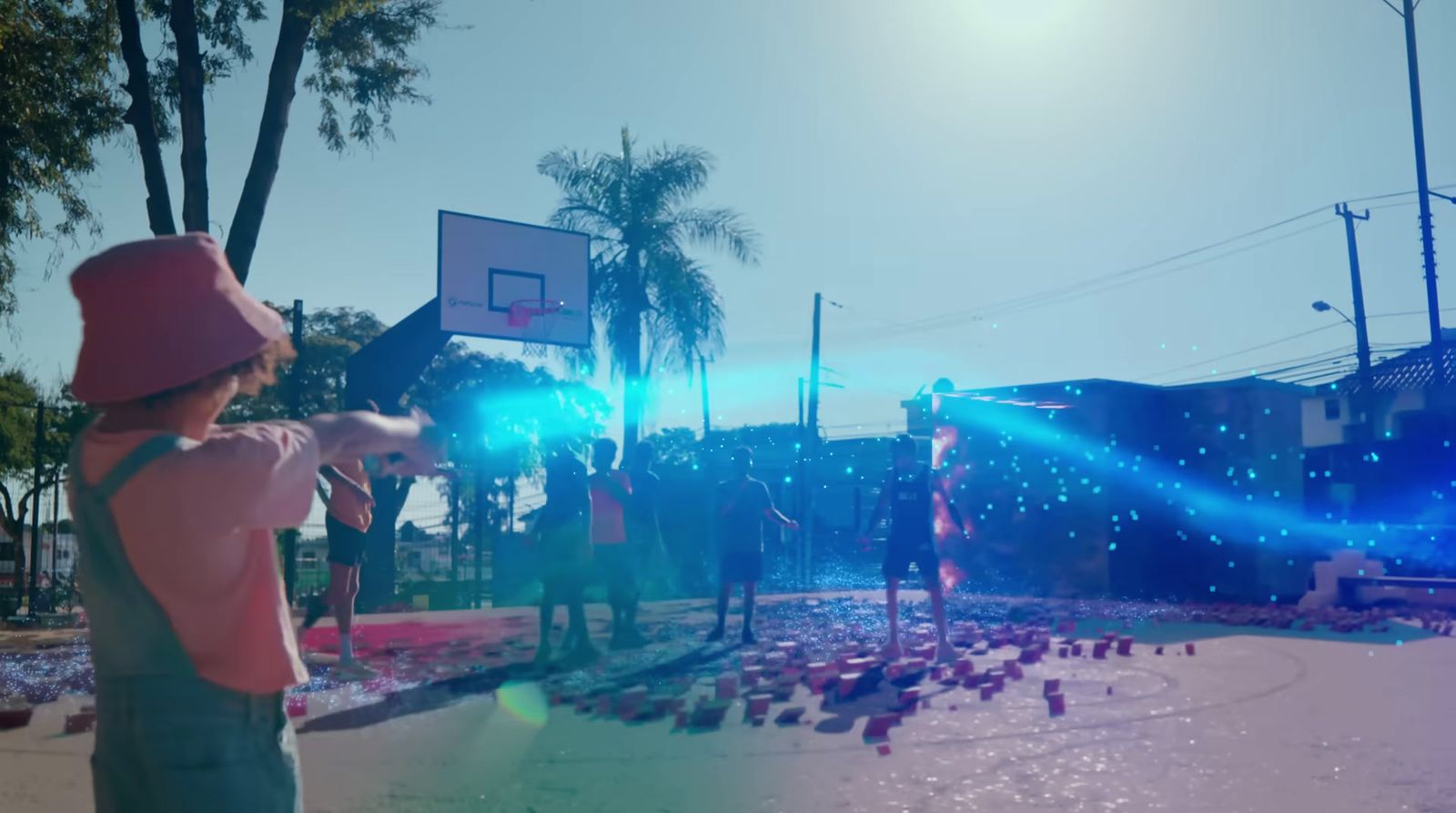 a group of people standing around a basketball court