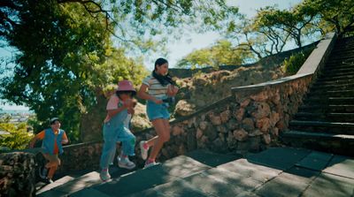 a group of people riding skateboards down a set of stairs