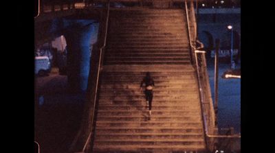 a person walking up a flight of stairs at night