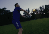 a man in a blue shirt throwing a frisbee