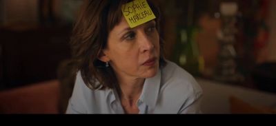 a woman with a sticky note on her head