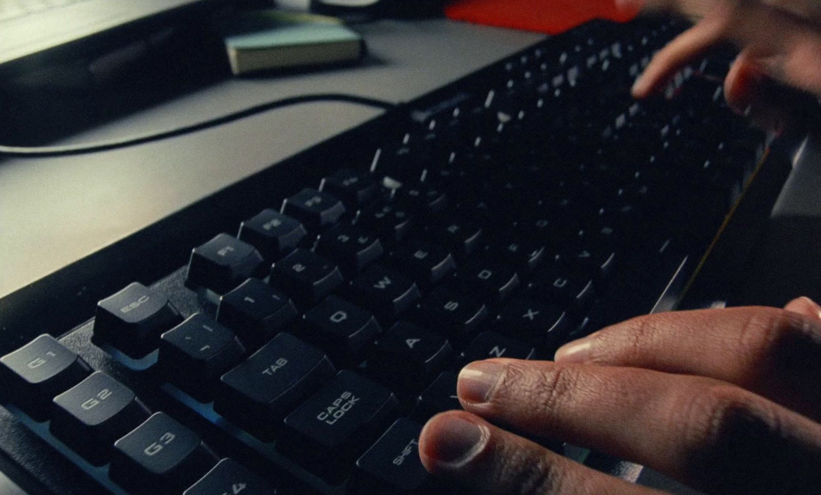 a person is typing on a computer keyboard