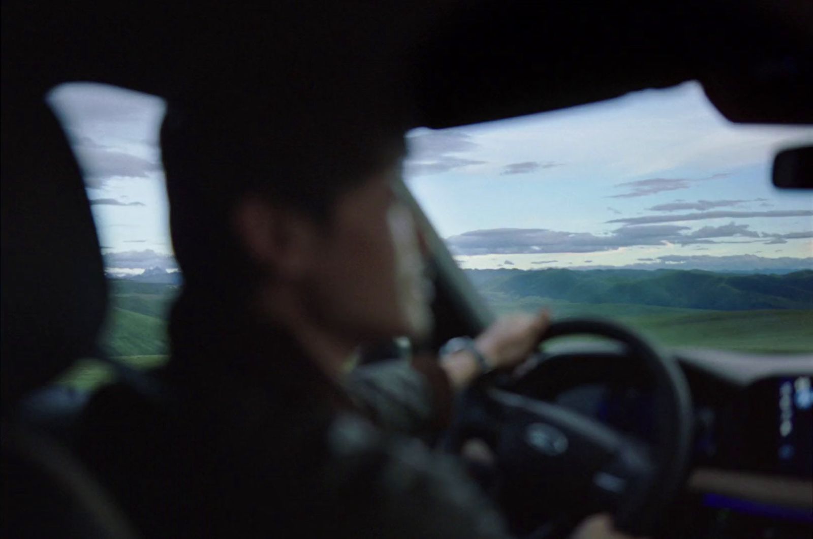 a man driving a car on a highway