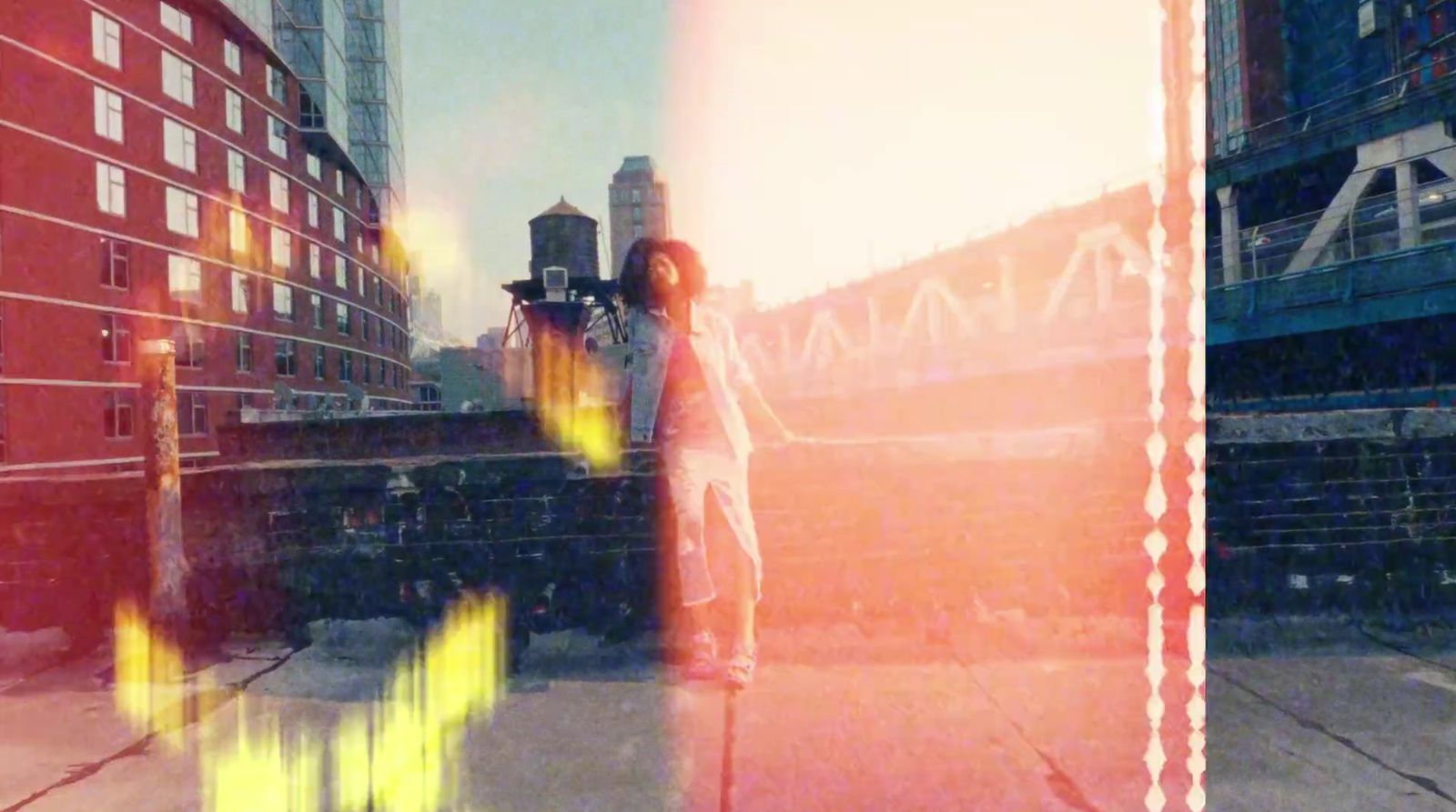 a woman standing on a sidewalk next to tall buildings