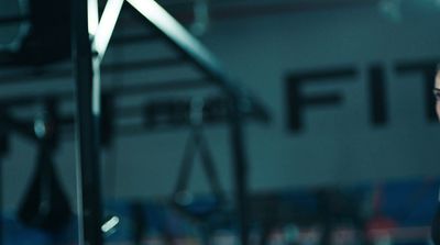 a woman in a gym looking at her cell phone