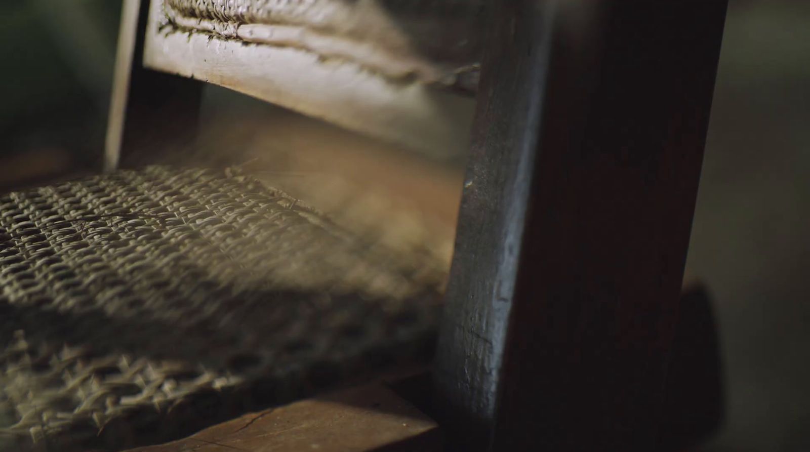 a close up of a wooden bench with a blurry background