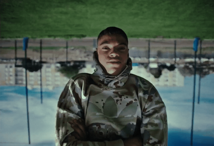 a man in camouflage jacket standing in front of a pool