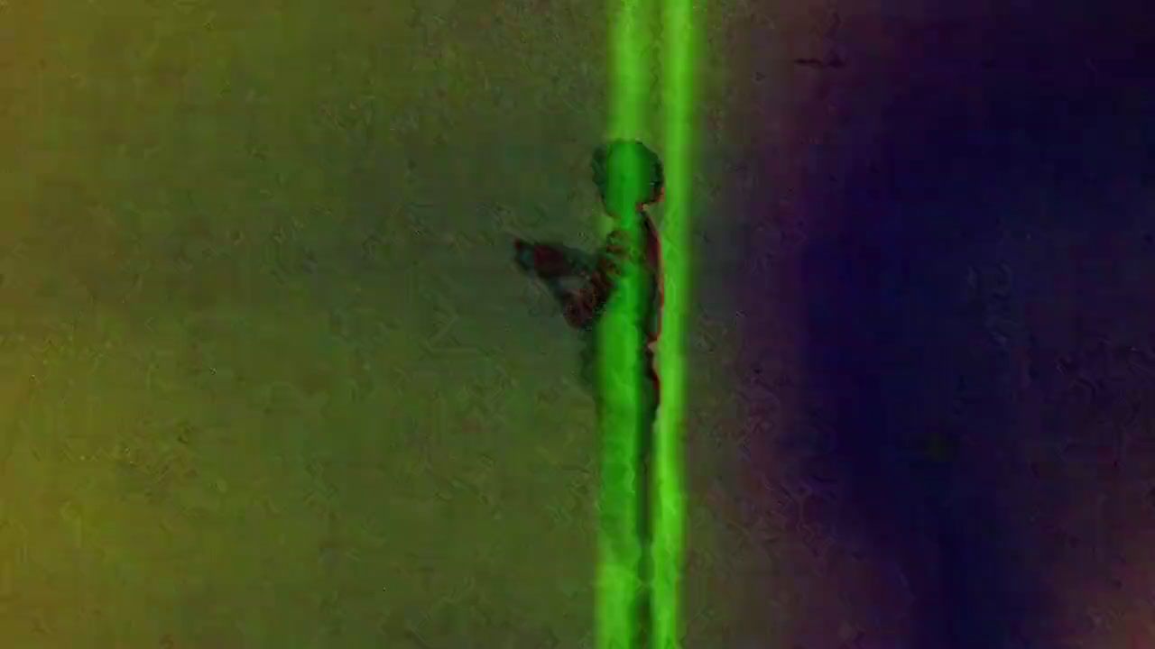 a blurry image of a green object on a wall