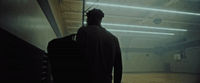 a man standing in a room with a suitcase