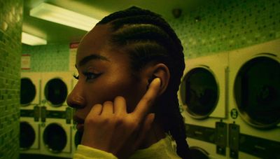 a woman with braids talking on a cell phone