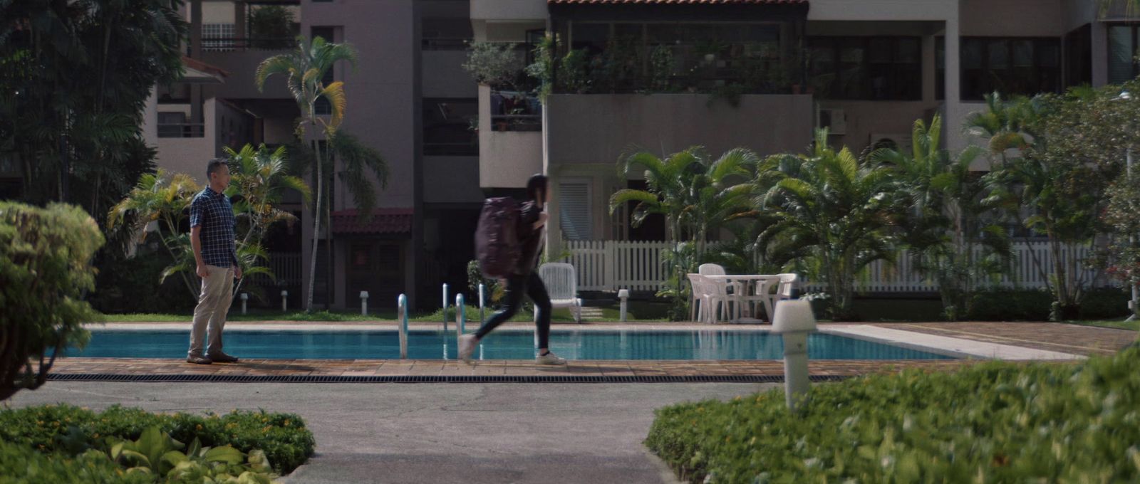 a couple of people that are standing in front of a pool