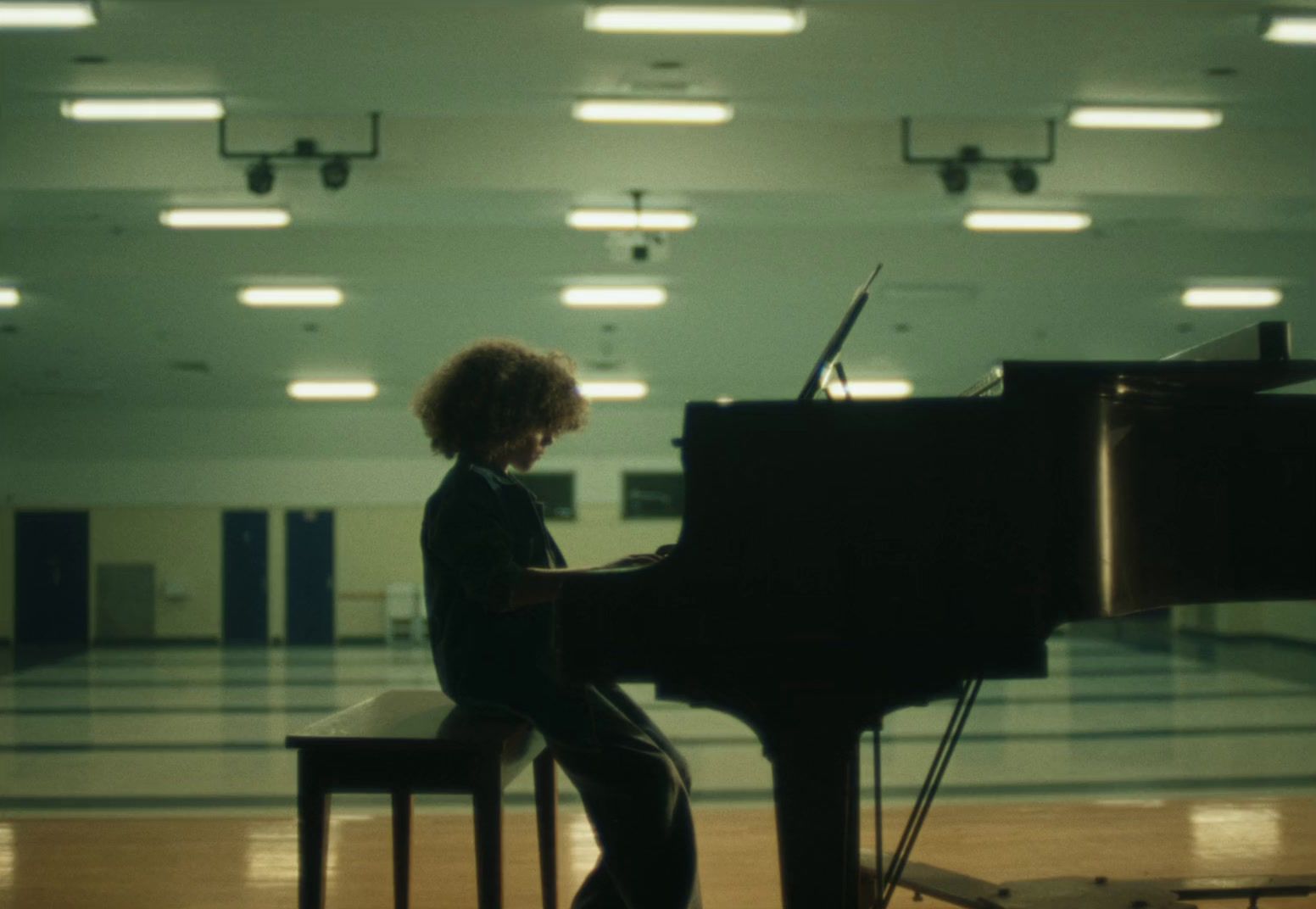 a person sitting at a piano in a room