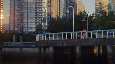 a person riding a skateboard across a bridge