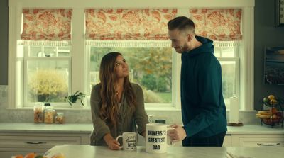 a man standing next to a woman in a kitchen