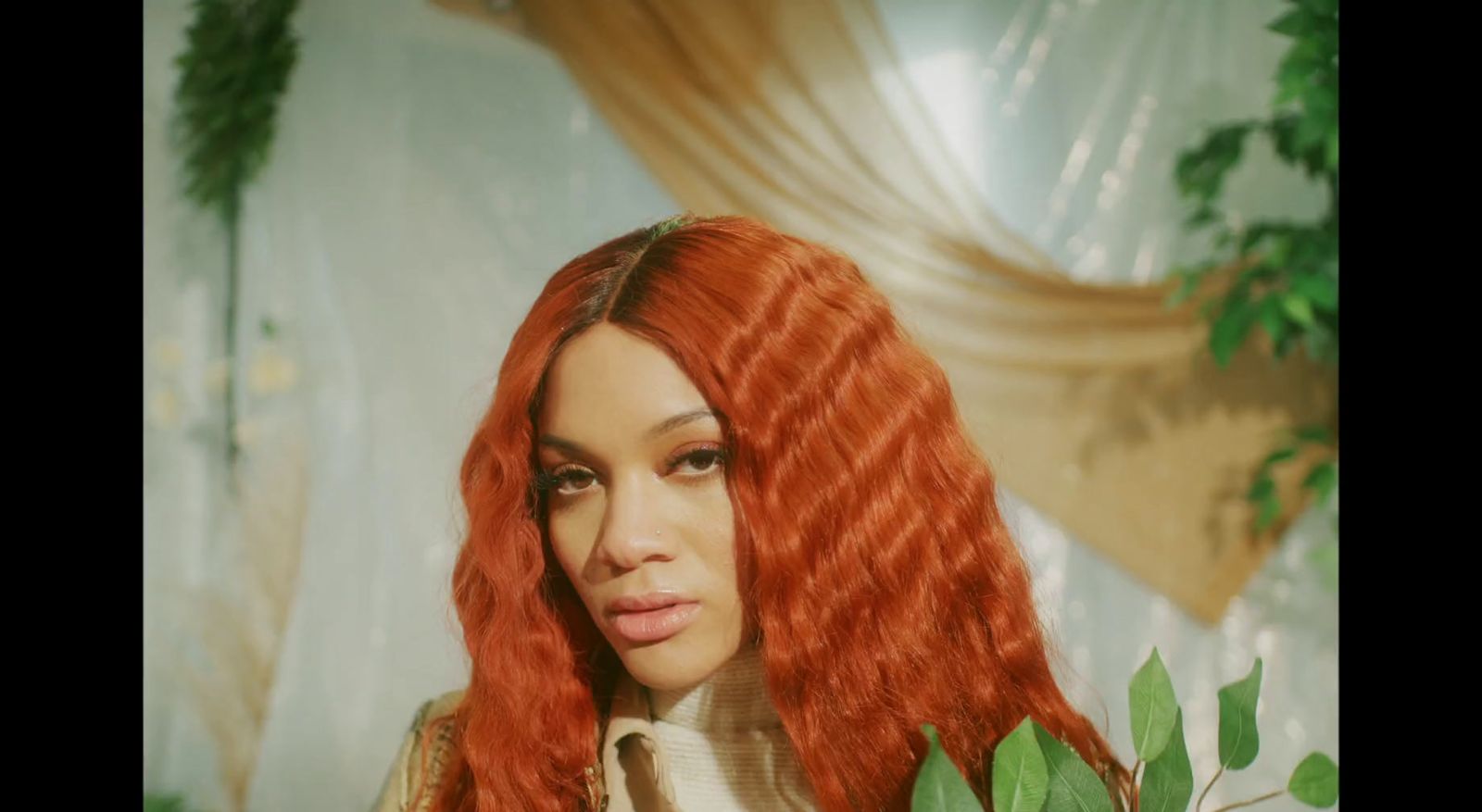 a woman with long red hair is posing for a picture