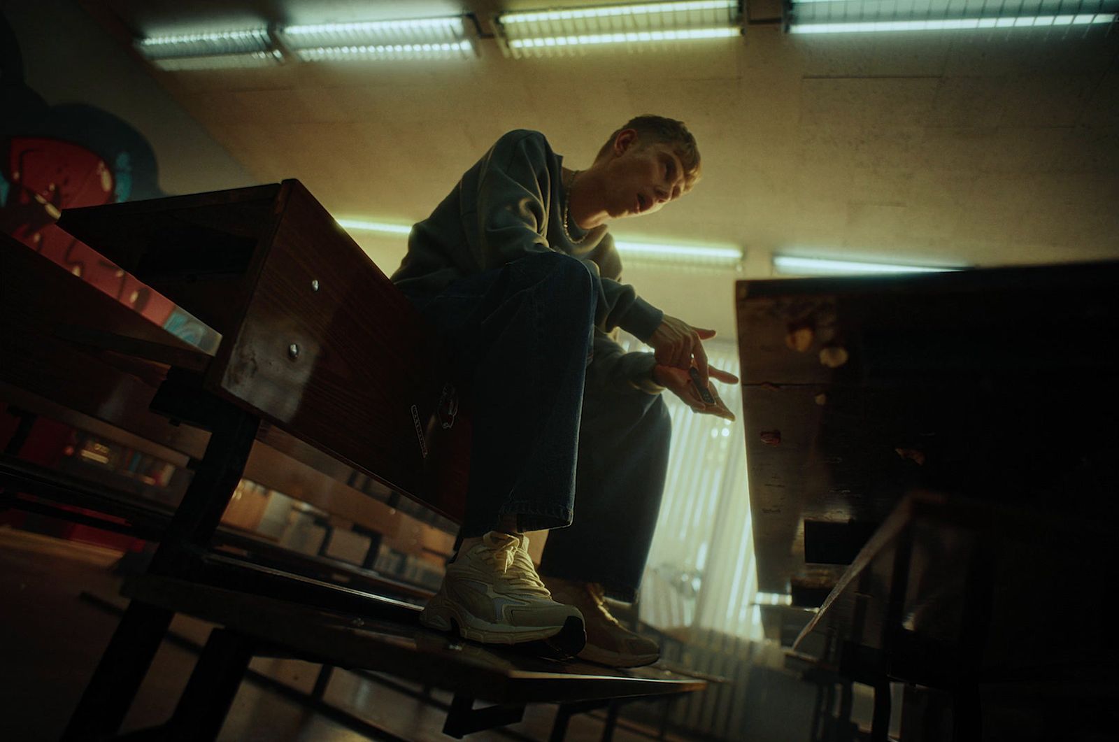 a man sitting on top of a wooden bench