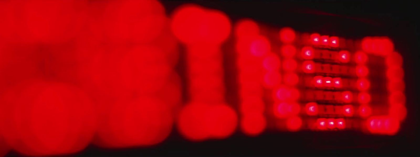 a close up of a computer keyboard with red lights