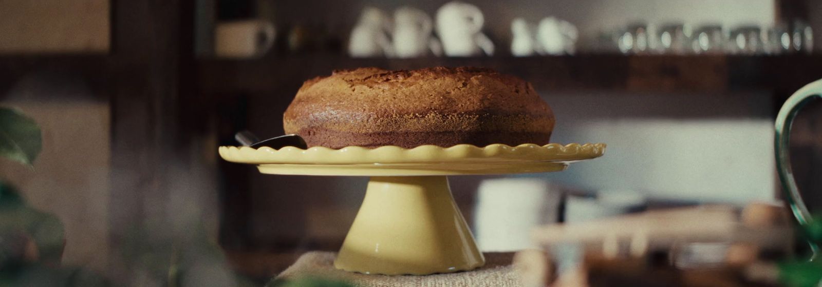 a cake sitting on top of a yellow cake plate