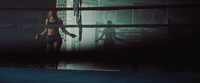 a woman is standing in a boxing ring