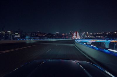 a view of a city at night from a moving car