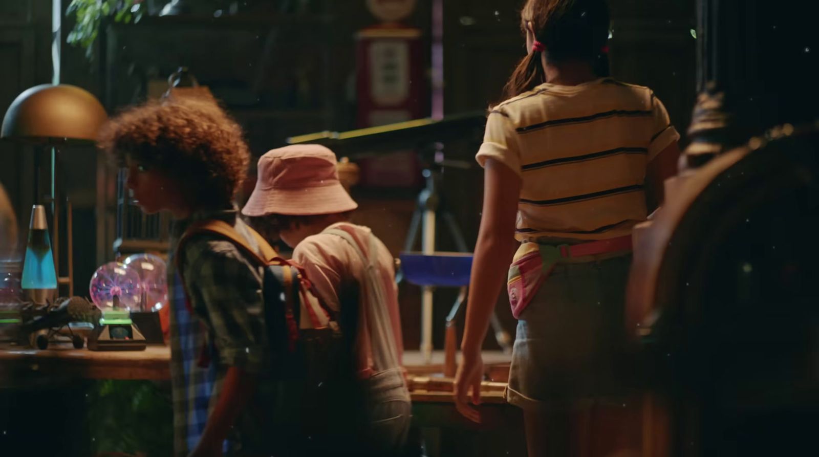 a group of young people standing around a room