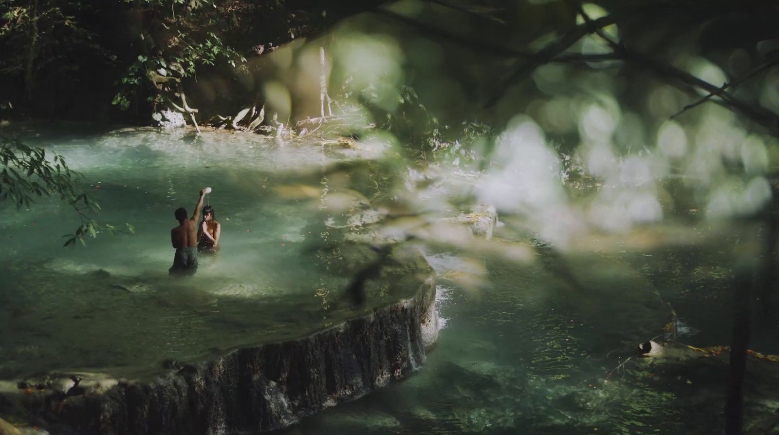 a couple of people standing in a pool of water