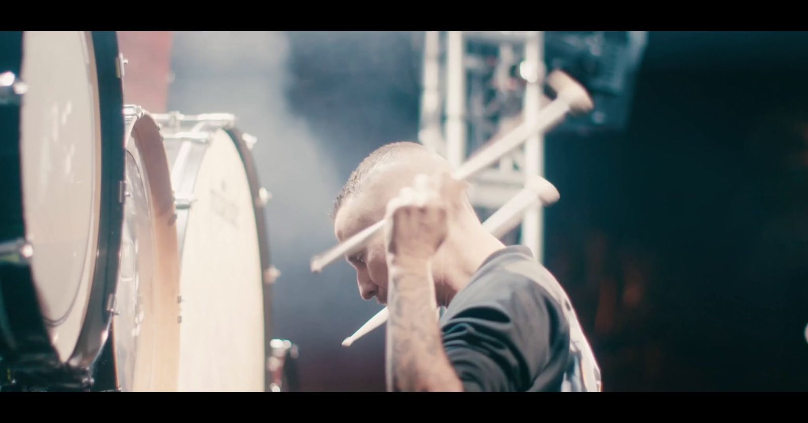 a man is playing drums on a stage