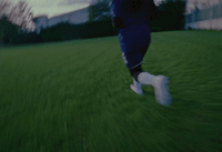 a blurry photo of a person running in a field