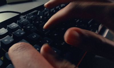 a person is typing on a computer keyboard