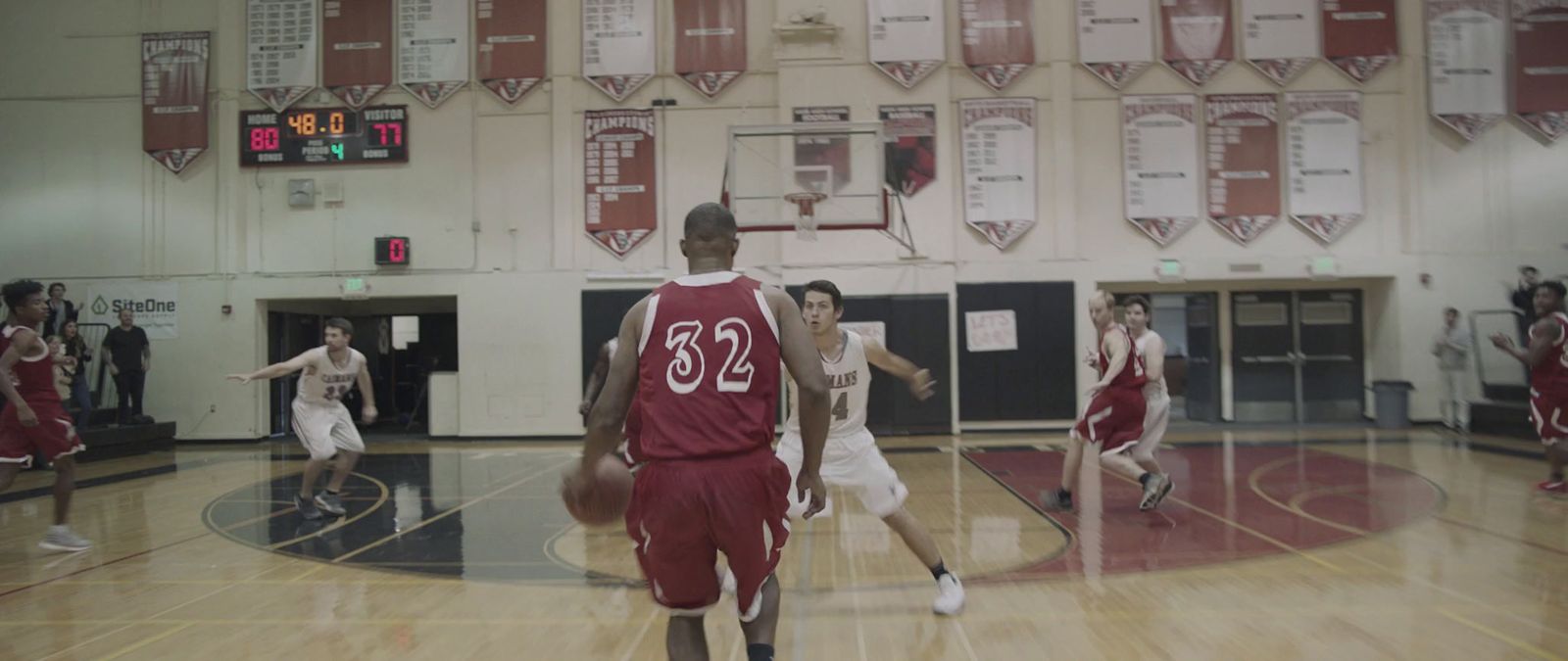 a group of young men playing a game of basketball