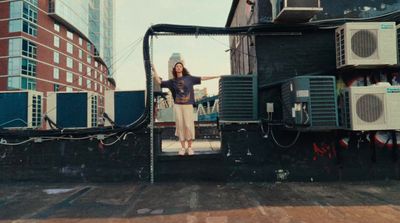 a woman standing on the back of a truck