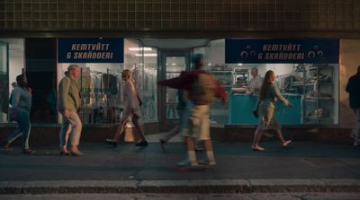 a group of people walking down a street at night