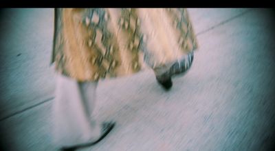 a blurry photo of a woman walking down a sidewalk